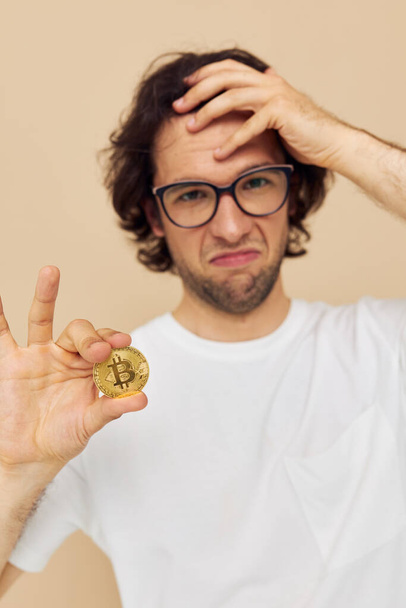 handsome man in a white T-shirt with Bitcoin cryptocurrency isolated background - Φωτογραφία, εικόνα