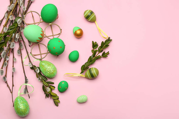 Willow branches and painted Easter eggs on pink background - Fotografie, Obrázek
