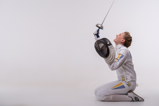 Young woman engaging in fencing - Фото, зображення