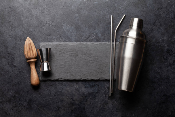 Various cocktail utensil set. Shaker, strainer, juicer. Top view flat lay with copy space - Фото, зображення