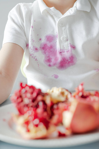 Close up dirty stain of fresh pomegranate on clothes.  - Photo, Image