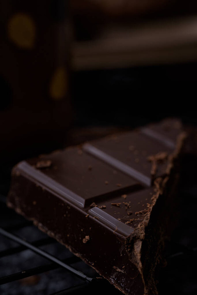 chocolate bars with nuts on a dark background - Фото, зображення