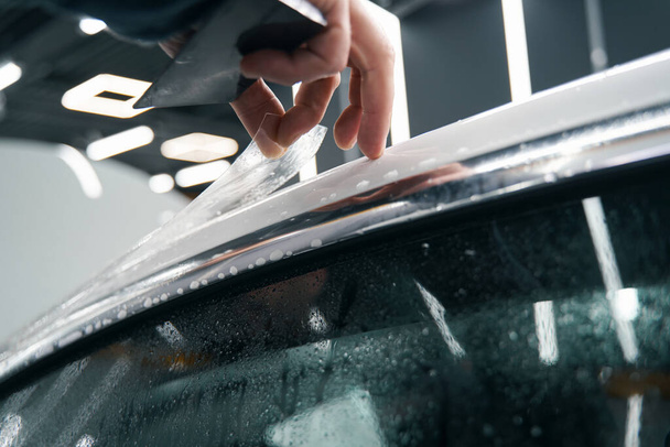 Professional detailer hand applying auto body coating - Photo, Image