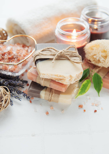 Concept of spa with natural organic handmade soap. Moisturizing skin care and aromatherapy. Gentle body treatment. Handmade soap. Atmosphere of harmony, relax. flowers, candle - Photo, Image