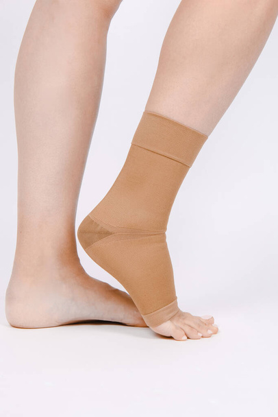 Orthopedic Ankle Brace. Medical Ankle Bandage. Medical Ankle Support Strap Adjustable Wrap Bandage Brace foot Pain Relief Sport. Leg Brace isolated on white background. Trauma Ankle orthosis. Injury - Zdjęcie, obraz