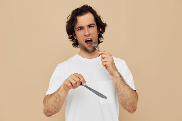 Attractive man cutlery in hand posing Lifestyle unaltered - Valokuva, kuva