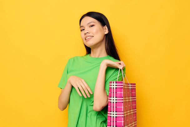 woman with Asian appearance entertainment shopping package isolated background unaltered - Photo, Image