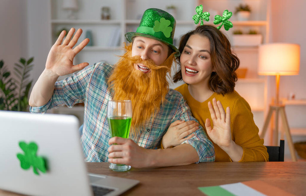 Happy family couple celebrating St. Patrick's Day with their friends by online at home. - Fotoğraf, Görsel