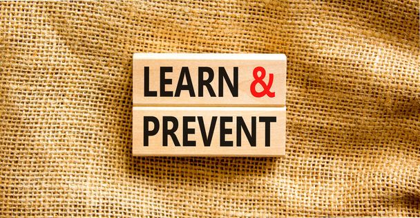 Learn and prevent symbol. Concept words Learn and prevent on wooden blocks on a beautiful canvas table canvas background. Business learning and learn and prevent concept, copy space. - Fotografie, Obrázek