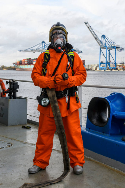 Fireman. Fire fighting equipment. Fire drill. Seaman with fire fighters outfits and Breathing apparatus. - Photo, Image