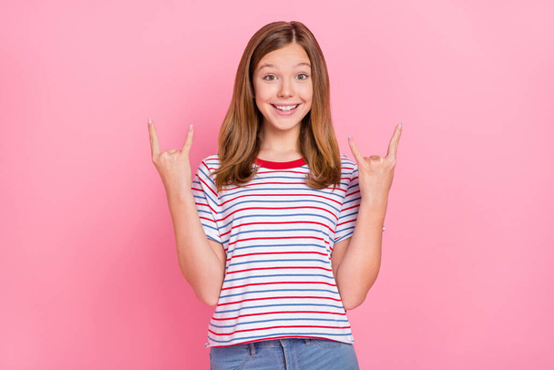 Photo of hooray teen blond girl show rock sign wear red t-shirt isolated on pink background - Foto, Bild