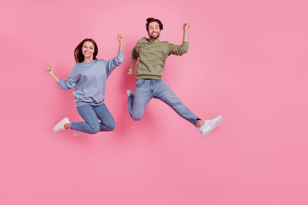 Full size photo of delighted two persons raise fists celebrate holiday success isolated on pink color background - Valokuva, kuva