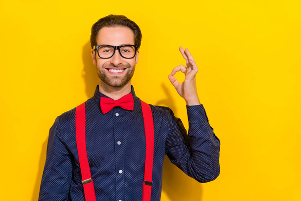 Photo of young man show fingers okey symbol feedback promo perfect isolated over yellow color background - Фото, зображення