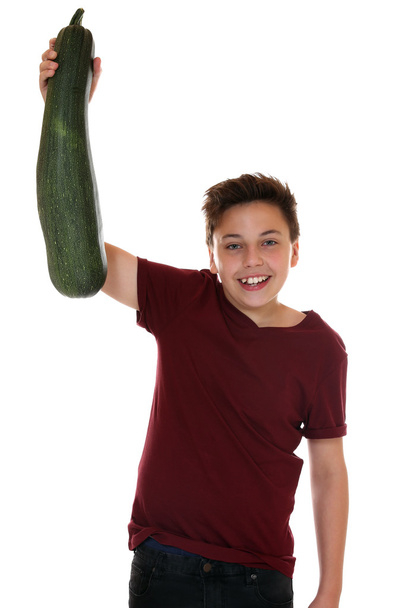 Healthy eating smiling teenager boy with zucchini - Foto, Bild