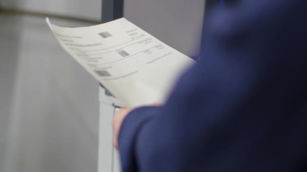 Worker scans a barcode from the sheet with a hand scanner. - Felvétel, videó