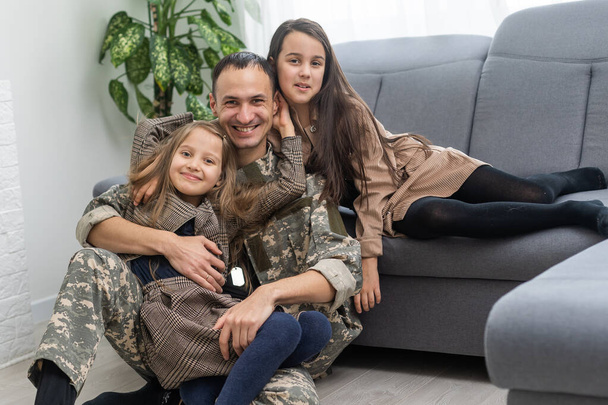 Happy military father and two daughters at home. - Photo, Image