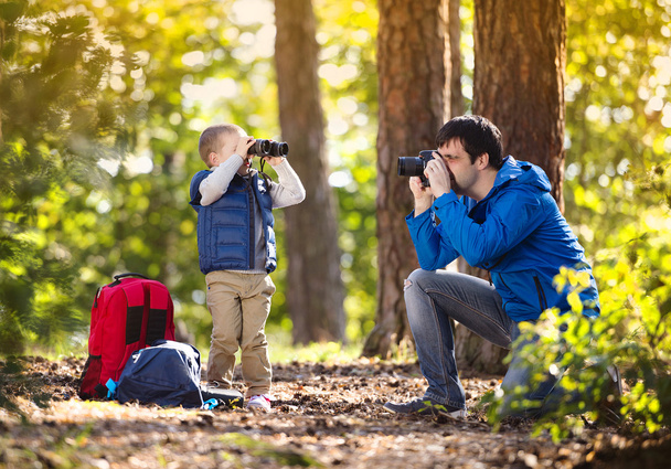 Father and son in the forest - 写真・画像