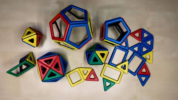 Magnetic multi-colored constructor for children in the form of geometric shapes. Development of young children through toys - Фото, изображение