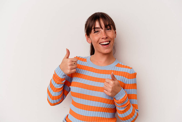 Young Argentinian woman isolated on white background raising both thumbs up, smiling and confident. - Photo, Image