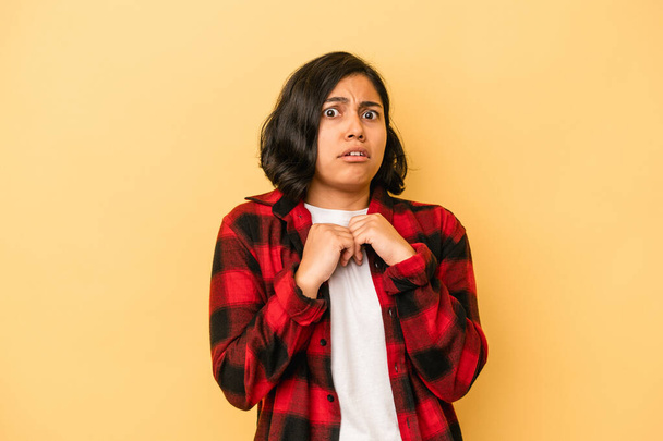 Young latin woman isolated on yellow background scared and afraid. - Photo, Image