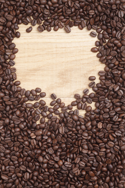 Caffe edition, coffee beans on a wooden background - Фото, изображение