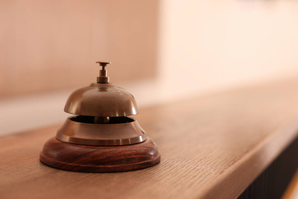 Hotel service bell on wooden reception desk. Space for text - Photo, Image