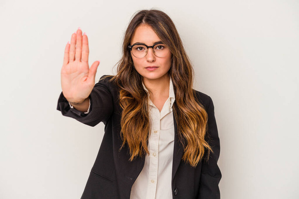 Young caucasian business woman isolated on white background standing with outstretched hand showing stop sign, preventing you. - 写真・画像