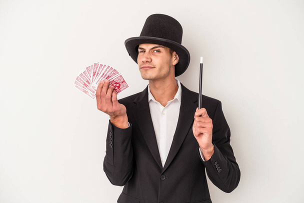 Giovane mago uomo caucasico in possesso di una carta magica isolata su sfondo bianco - Foto, immagini
