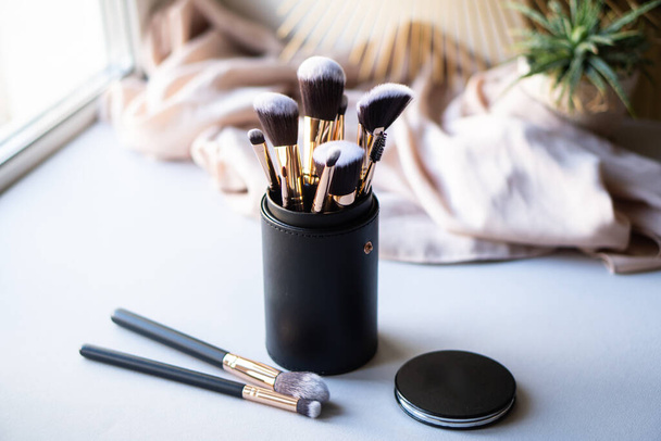 Set of luxurious black makeup brushes in leather case - Photo, Image
