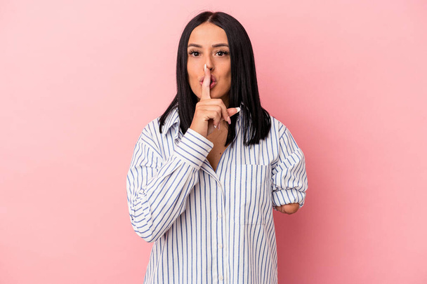 Young caucasian woman with one arm isolated on pink background keeping a secret or asking for silence. - Photo, Image