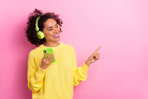 Photo of charming female promote product new smartphone phone version isolated on pink color background - Fotoğraf, Görsel