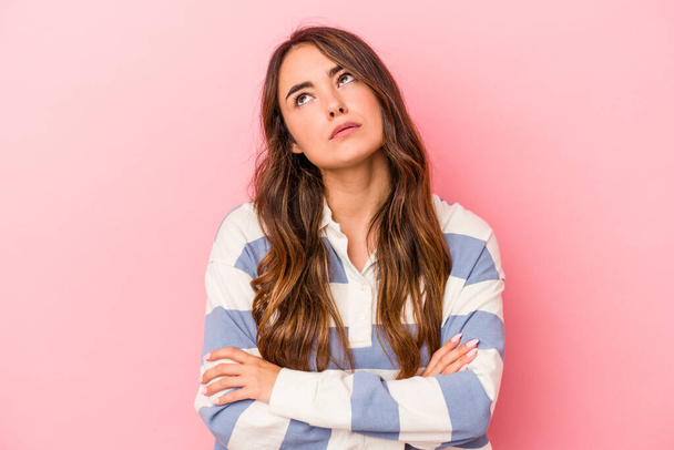 Young caucasian woman isolated on pink background tired of a repetitive task. - Photo, Image