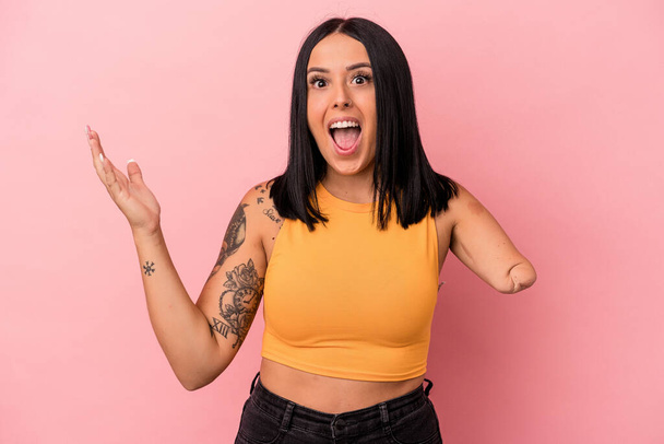 Young caucasian woman with one arm isolated on pink background receiving a pleasant surprise, excited and raising hands. - Foto, immagini