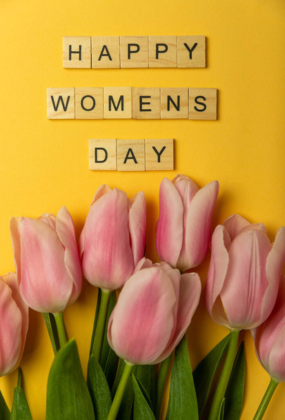 Mezinárodní den žen. Krásná pohlednice na 8. března. Jarní kytice růžových tulipánů s nápisem Šťastný den žen na žlutém pozadí. Koncept dovolené. Rozumím. Flatley - Fotografie, Obrázek