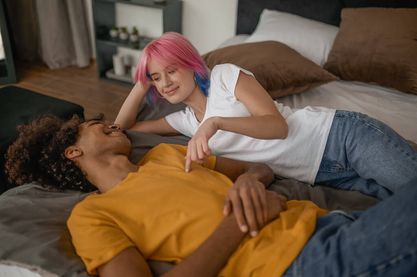 Young couple laying in bed and looking relaxed - Photo, image