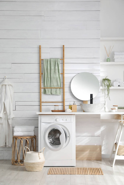 Stylish bathroom interior with modern washing machine - Foto, imagen