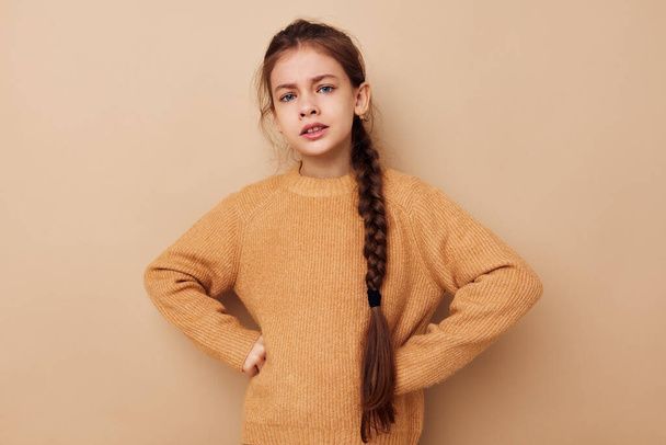 little girl long pigtail beige sweater grimace childhood unaltered - Zdjęcie, obraz