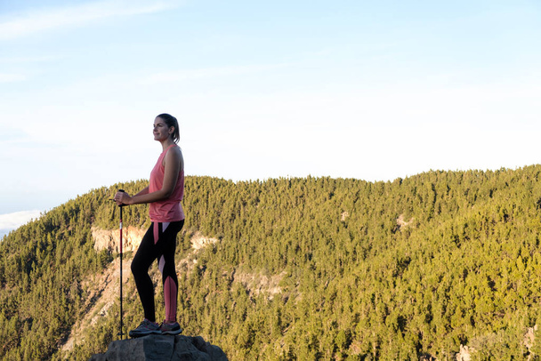 Woman in the foreground hiking on top of the mountain - Photo, Image