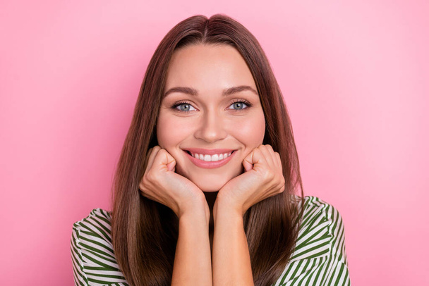 Photo of dreamy adorable lady dressed green shirt arms cheeks smiling isolated pink color background - Zdjęcie, obraz