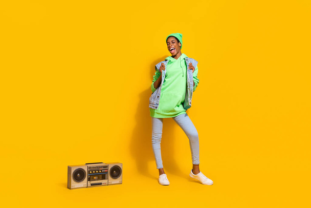 Full body photo of overjoyed funky person chill entertainment vintage radio isolated on yellow color background - Fotoğraf, Görsel