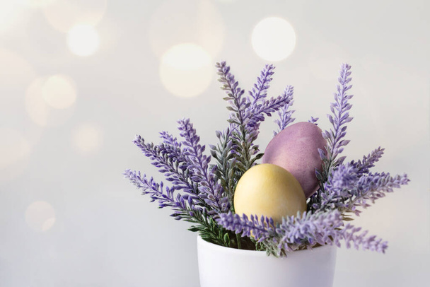 beautiful Easter card with colored eggs in purple flower - Photo, image