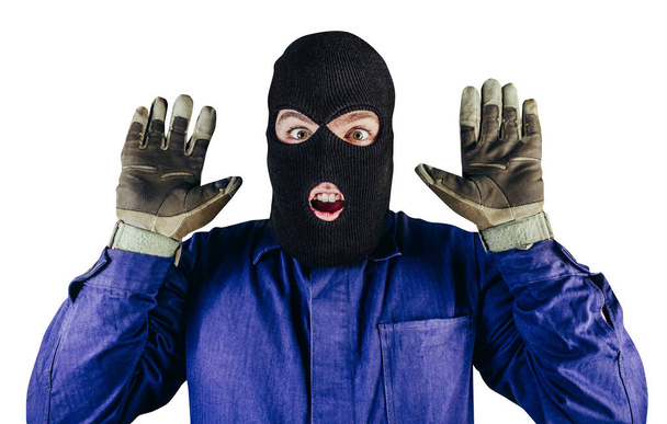 Isolated photo of robber in mask, overalls, gloves putting hands up on white background. - Photo, Image