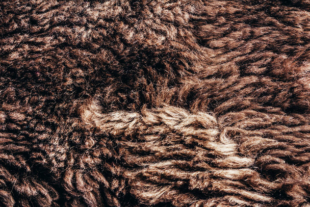 Backdrop close-up photo texture of brown colored synthetic fur material. - Photo, Image