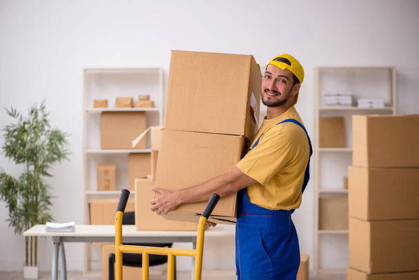Young male contractor doing home relocation - Photo, Image