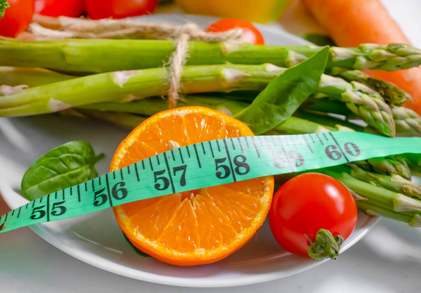fresh vegetables, measuring tape on wooden background - Photo, Image