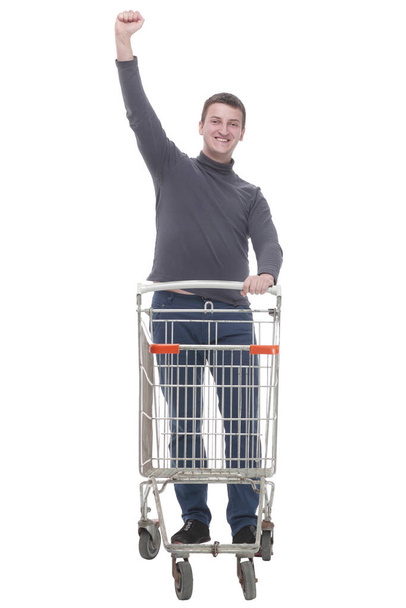 in full growth. casual young man with shopping cart. - Photo, image