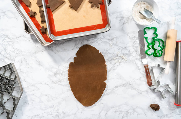 Flat lay. Baking gingerbread cookies with Christmas shapes. - Foto, Imagem