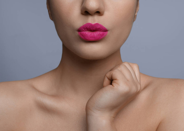 Closeup view of woman with beautiful full lips on grey background - Valokuva, kuva