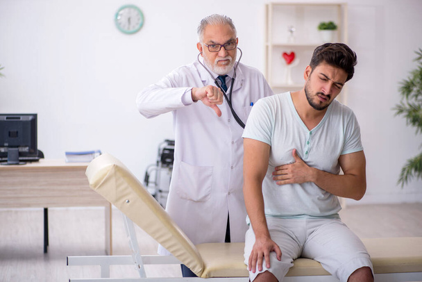 Young male patient visiting old male doctor - Photo, Image