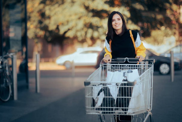 Happy Supermarket Customer Pushing a Shopping Cart - Φωτογραφία, εικόνα